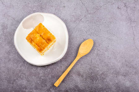 Close up square cut of homemade sweet and soft carrot cake on white plate on table. Delicious and healthy bakery.の写真素材