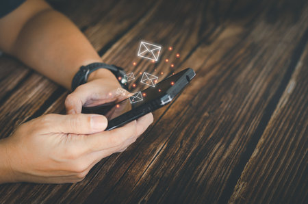Businessman reading and sending electronic mail from the smartphone, doing business and global online marketing with communicating wirelessly.の写真素材