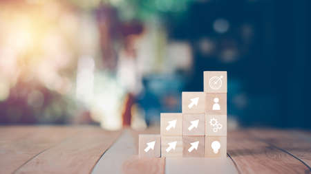 Goal and plan business concept. Stack of wooden cube blocks with icons. The action plan, success,...