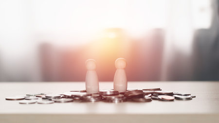 Business contact and financial concept. Two wooden figures standing on piles of coins, business negotiations, trading dealings, brokers.の写真素材