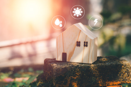 Eco-friendly house concept. The wooden home stands on older brick with energy icons and a green background, and copy space. Natural sustainable.の写真素材