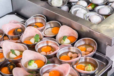 Street Chinese appetizer. Variety of dumplings or dim sum on the small metal plate.
