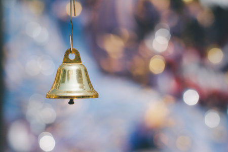 Christmas bell on bokeh background.
