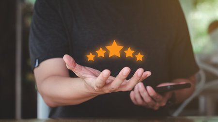 Reward and Satisfaction Concept. Businessman showing and giving five stars on hand. Business Quality Assessment, ISO, Quality Assurance, Certification.の写真素材