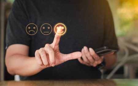 Customer satisfaction assessment and concept. Customers or business people use mobile phones to evaluate the services from the application and give a rating and pointing smile face popup.の写真素材