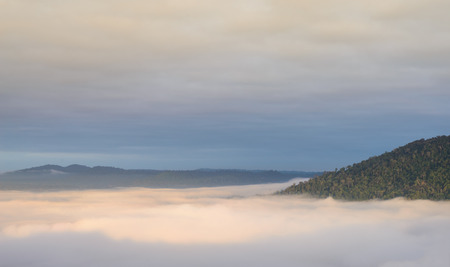 Sea fog over the hill in the morningの写真素材