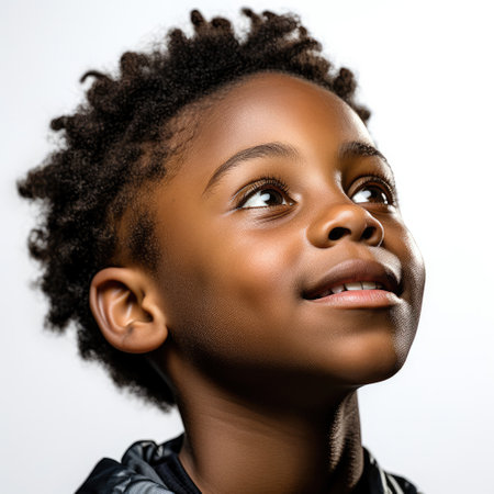 Professional studio head shot of a young boy lost in thought.の素材