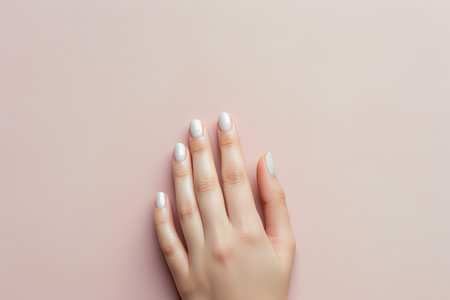 Experience the gentle touch as a close-up captures a female hand against a backdrop of soft pastel hues, creating a visually soothing and tender atmosphereの素材