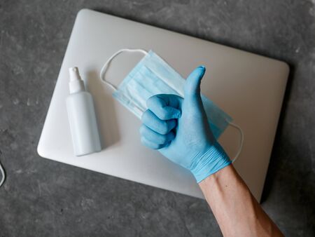 Face mask, Medical mask, Surgical mask with Eyeglass on laptop, Wooden texture background, Close up shot, Selective focus, Prevention from covid19, Coronavirus, Bacteria, Healthcare.の写真素材