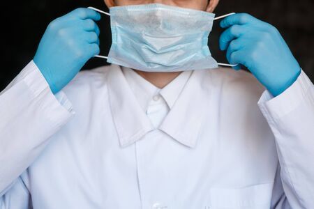 Coronavirus surgical mask doctor wearing face protective mask against corona virus banner panoramic medical professional preventive gear.の写真素材