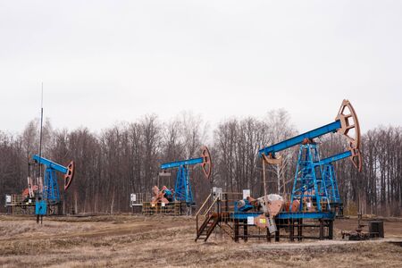 Green Oil pump oil rig energy industrial machine for petroleum crude. oil crisis. Russia pumps oil pollutionの写真素材