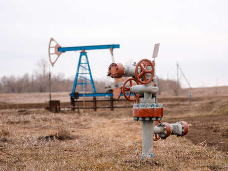 Green Oil pump oil rig energy industrial machine for petroleum crude. oil crisis. Russia pumps oil pollutionの写真素材