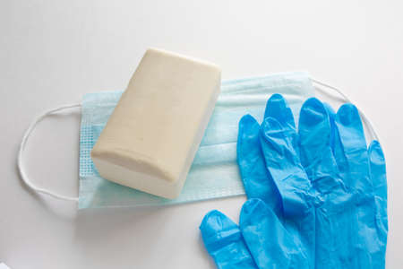 Pair of latex medical gloves, medical masks, sanitizer gel for hand hygiene, remedies, soap, disinfector. Coronavirus prevention white background.の写真素材