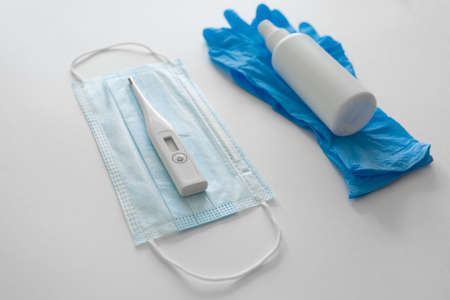 Flat lay of Coronavirus protection, medical protective masks, gloves, hand sanitizer bottles, antiseptic, disinfection, spray on white background isolated , copy spaceの写真素材