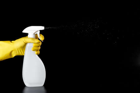 household cleaner, white spray in the hands with yellow rubber gloves.の写真素材