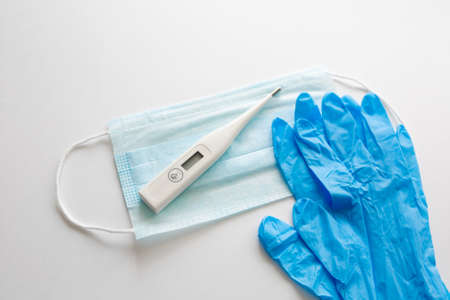 Flat lay of Coronavirus protection, medical protective masks, gloves, hand sanitizer bottles, antiseptic, disinfection, spray on white background isolated , copy spaceの写真素材