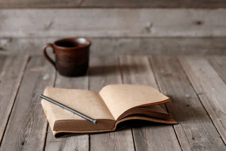 Office desk with blank screen smartphone,pen,notebook and coffee cup on wood table.Top view with copy space.Office supplies and gadgets on desk table.Working desk table concept.Flat lay image.の写真素材