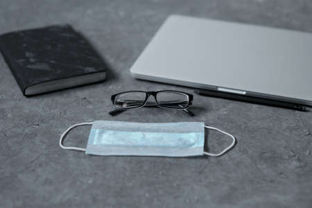 Work from home. Keyboard, phone, protective medical mask, antiseptic on the table. The concept of...