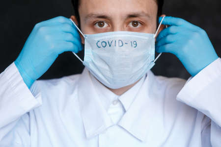 Coronavirus surgical mask doctor wearing face protective mask against corona virus banner panoramic medical professional preventive gear.の写真素材