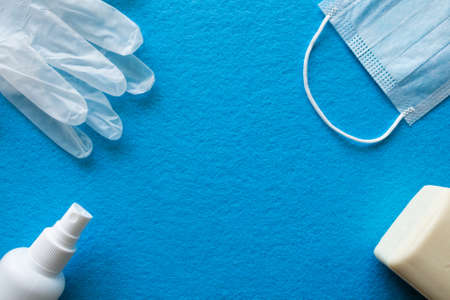 latex medical gloves, face medical mask, thermometer and antiseptic soap. covid-19 concept. pandemic essentials set copy spaceの写真素材