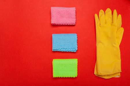 gloves and rags on a red background. Copyspace