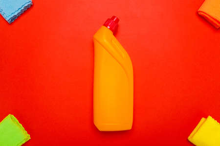 yellow toilet cleaner with rags on a red background.の写真素材