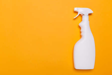 white bottle with glass cleaning liquid for glasses on a yellow background, place for text.の写真素材