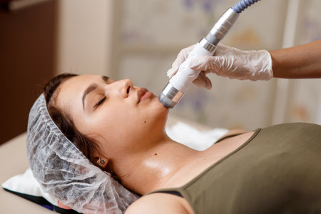 Lymphatic drainage massage LPG apparatus process. Therapist beautician makes a rejuvenating facial massage for the woman in a SPA salon. Beauty and bodycare concepの写真素材
