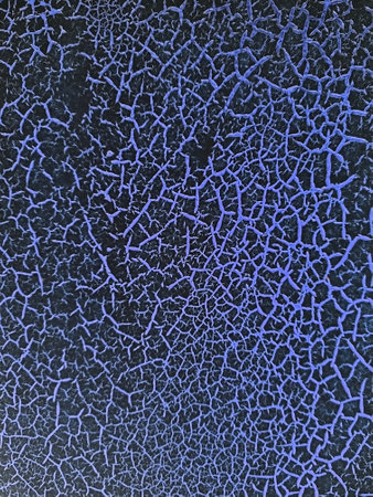Texture of blue scratches paint on a black background. Craquelure, vintage, retro. Selective focus.