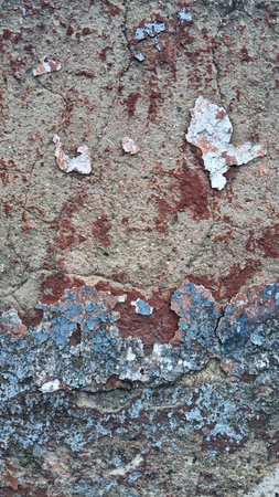 Texture of old rustic wall covered with gray and blue stucco. Multilayers of old paint on the wall....