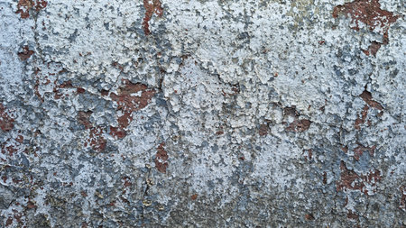 Texture of old rustic wall covered with gray and blue stucco. Multilayers of old paint on the wall....