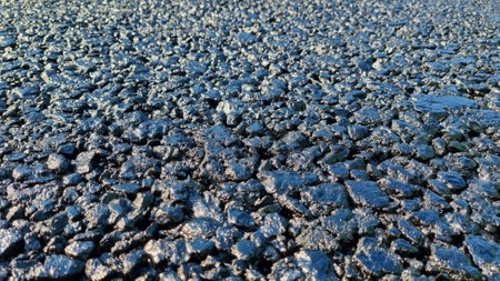 New laid asphalt road, large crushed stone. Close-up. Background.の写真素材
