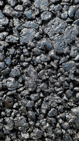 New laid asphalt road, large crushed stone. Close-up. Background.の写真素材