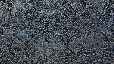 New laid asphalt road, large crushed stone. Close-up. Background.の写真素材