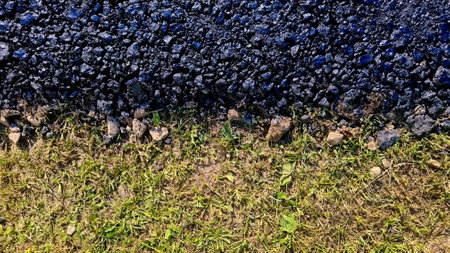 new asphalt road texture with green grass for background. Top view. Selective focusの写真素材