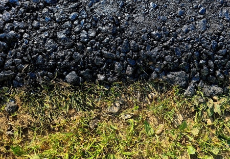 new asphalt road texture with green grass for background. Top view. Selective focusの写真素材
