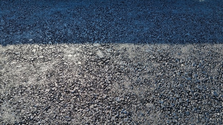 New laid asphalt road, large crushed stone. Close-up. Background.の写真素材