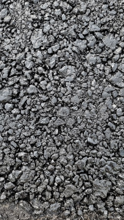 New laid asphalt road, large crushed stone. Close-up. Background.の写真素材