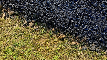 new asphalt road texture with green grass for background. Top view. Selective focusの写真素材