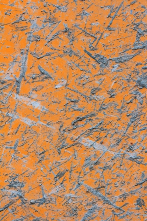 Yellow metal plate with splashes of cementの写真素材