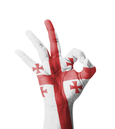 Hand making Ok sign, Georgia flag painted as symbol of best quality, positivity and success - isolated on white backgroundの写真素材