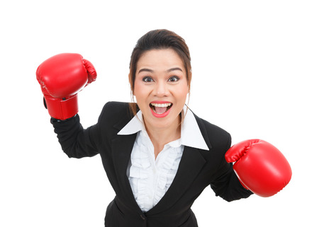 Asian business woman with boxing gloves isolated on white backgroundの写真素材