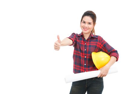 Asian engineer woman thumbs up with blueprints isolated on white backgroundの写真素材