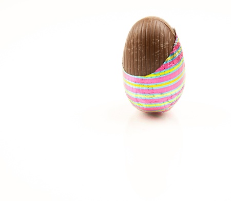 Chocolate easter egg partially unwrapped の写真素材