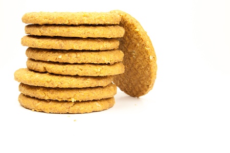 stacked wholemeal cookies on a white background の写真素材