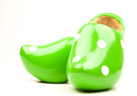 Green wooden shoes with white dots with a white background の写真素材
