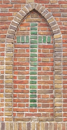 Brick wall with green cross の写真素材
