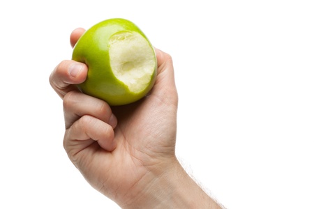 Hand holding green apple with bite missing on a white backgroundの写真素材