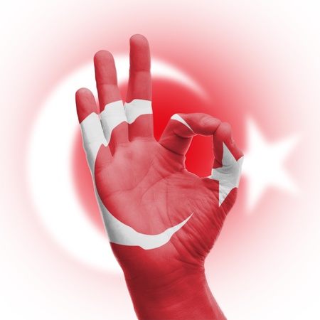 hand OK sign, wrapped in the flag of Turkeyの写真素材
