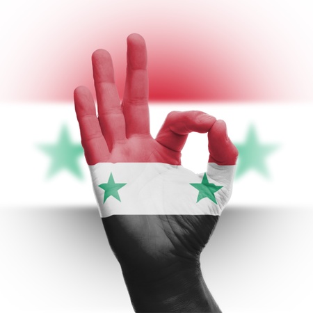 hand OK sign, wrapped in the flag of Italyの写真素材